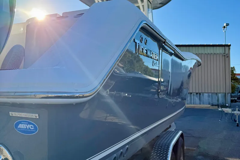 Slide: The Image of 2026 Tidewater 282 CC Adventure boat with sunlit hull and ABYC certification. - 7