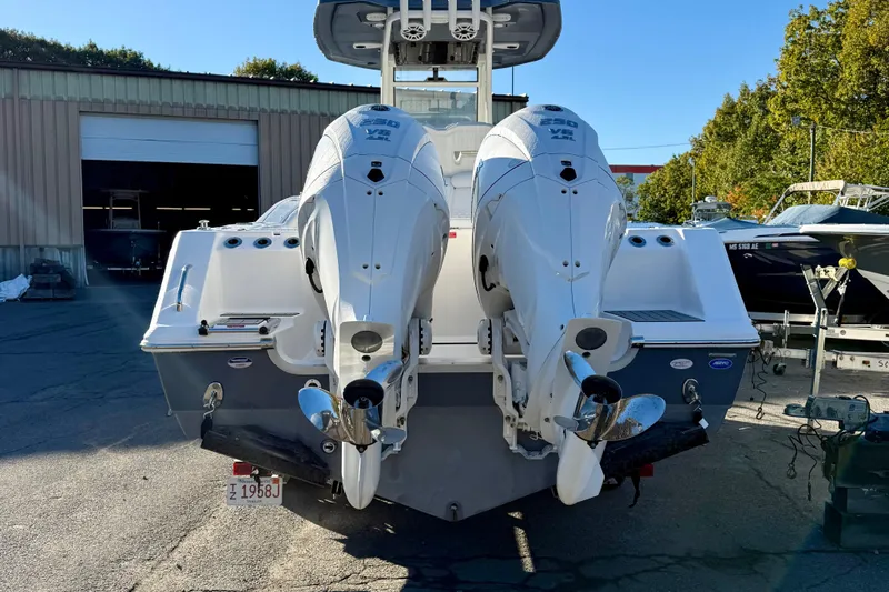Slide: The Image of 2026 Tidewater 282 CC Adventure boat with dual outboard engines, parked outdoors. - 8