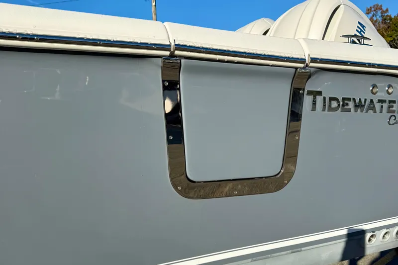 Slide: The Image of 2026 Tidewater 282 CC Adventure boat side view with logo and chrome details. - 9