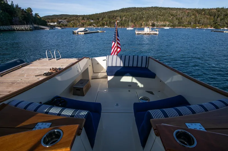 Slide: The Image of Hinckley Talaria 34 boat interior, 2013 model, docked in scenic harbor with American flag. - 11