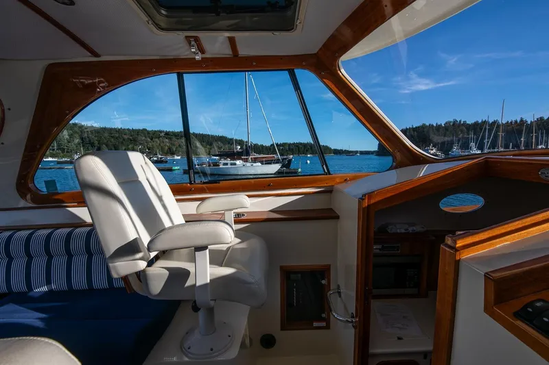 Slide: The Image of Interior view of 2013 Hinckley Talaria 34 yacht with scenic harbor backdrop. - 15