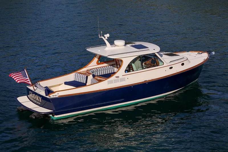 Slide: The Image of 2013 Hinckley Talaria 34 yacht cruising on calm blue waters. - 4