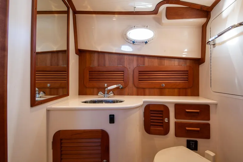 Slide: The Image of Luxurious 2013 Hinckley Talaria 34 yacht bathroom with wood accents and modern fixtures. - 21