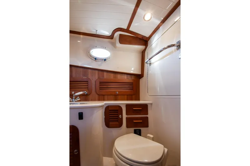 Slide: The Image of Luxurious 2013 Hinckley Talaria 34 yacht bathroom with wood accents and modern fixtures. - 22