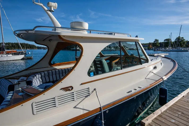 Slide: The Image of 2013 Hinckley Talaria 34 yacht docked by the water on a sunny day. - 7