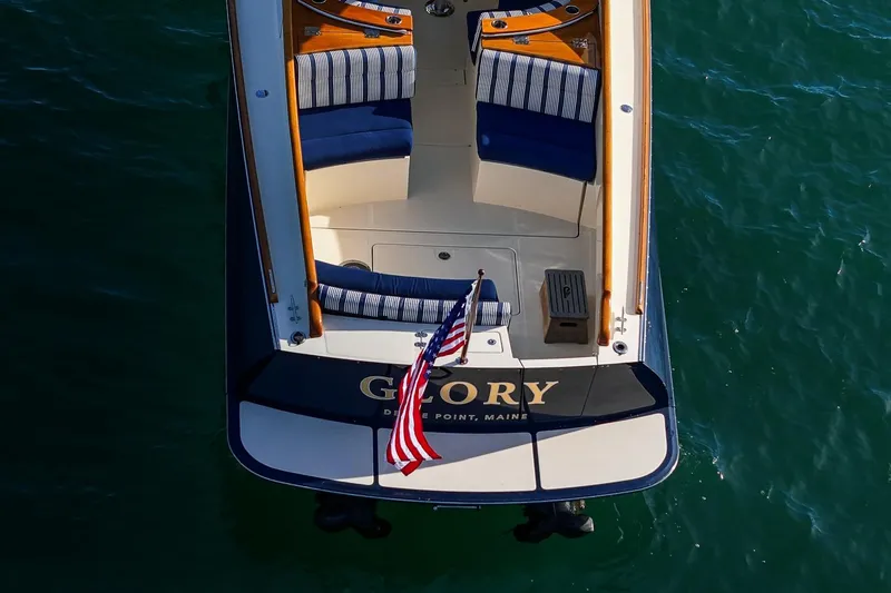 Slide: The Image of Aerial view of 2013 Hinckley Talaria 34 boat with striped seating and American flag. - 9