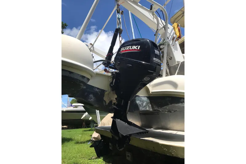 Slide: The Image of Outboard motor on 1999 Custom Sport Fishing boat, Suzuki engine, sunny day. - 11
