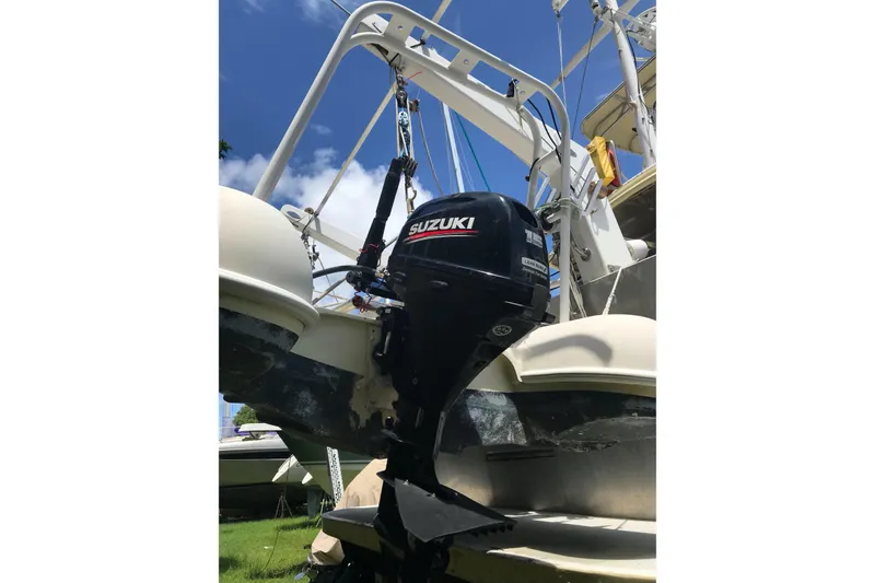 Slide: The Image of Outboard motor on a 1999 Custom Sport Fishing boat under clear blue sky. - 12