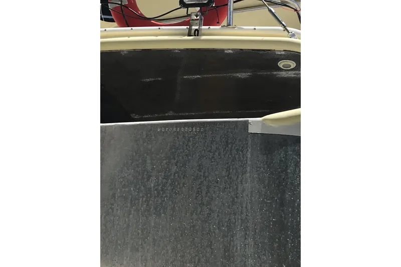 Slide: The Image of 1999 Custom Sport Fishing boat hull with visible identification number. - 13