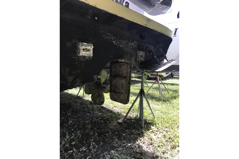 Slide: The Image of 1999 Custom Sport Fishing boat on stands, showing propeller and hull details. - 16