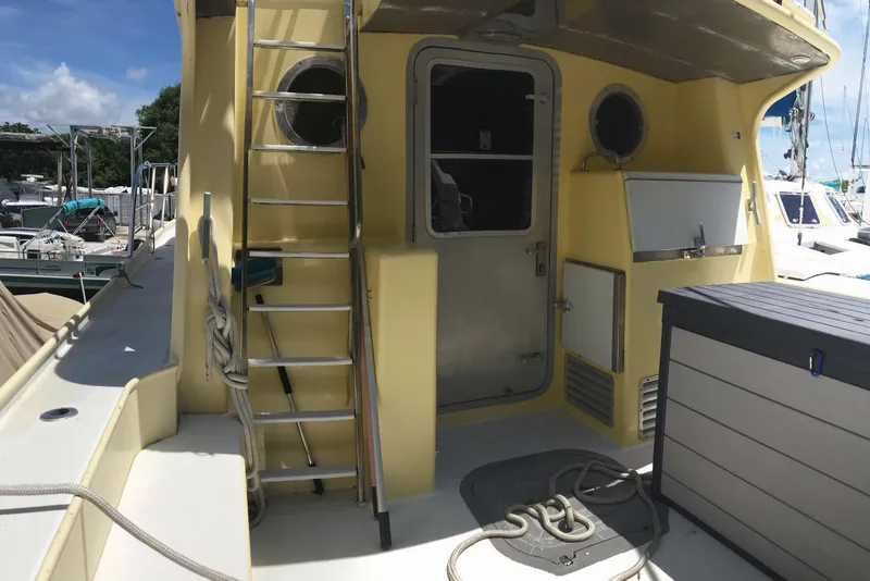 Slide: The Image of 1999 Custom Sport Fishing boat deck with ladder, storage, and equipment. - 21