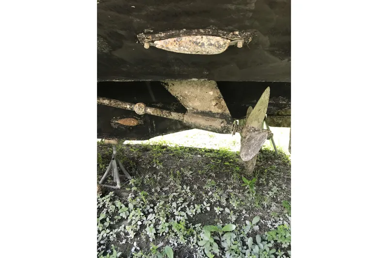 Slide: The Image of Underside of a 1999 Custom Sport Fishing boat showing propeller and rudder. - 28