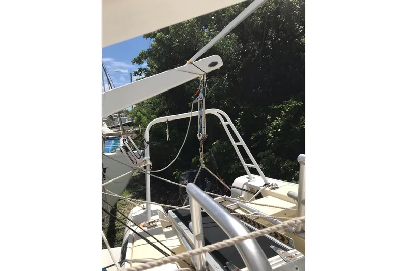 Slide: The Image of Custom 1999 Sport Fishing boat with rigging and equipment, docked near lush greenery. - 31