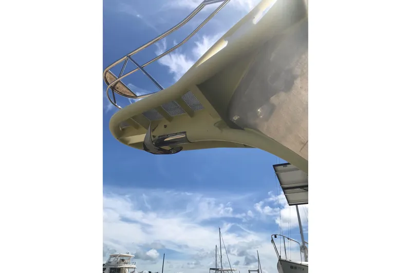 Slide: The Image of Custom 1999 Sport Fishing boat with blue sky background, featuring a sleek design. - 32