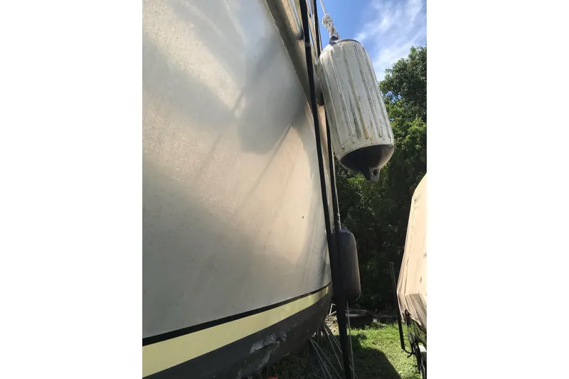 Slide: The Image of 1999 Custom Sport Fishing boat with fenders, docked outdoors. - 33