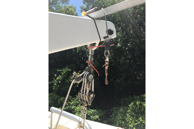 Slide: The Image of Hanging rigging equipment on a 1999 Custom Sport Fishing boat against a forest backdrop. - 35