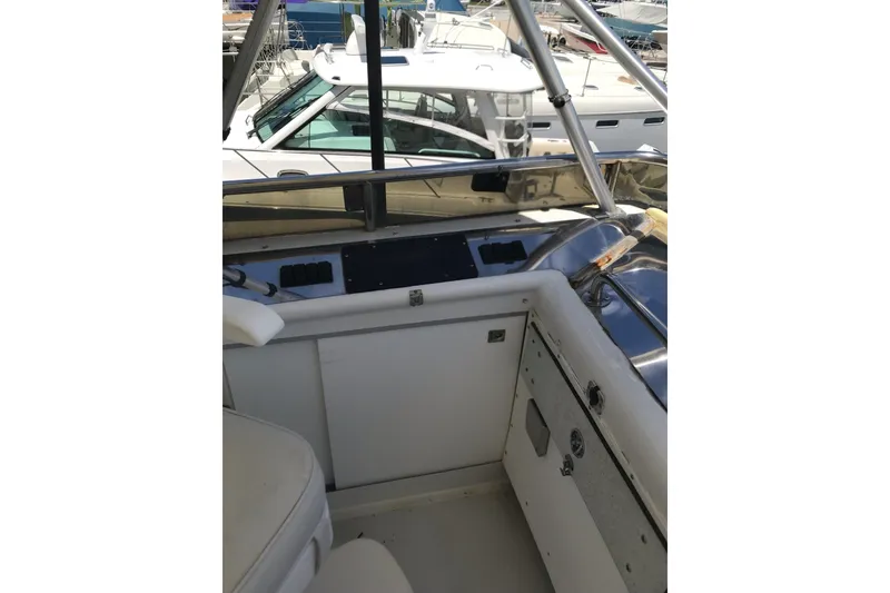 Slide: The Image of Interior view of a 1999 Custom Sport Fishing boat with seating and control panel. - 39