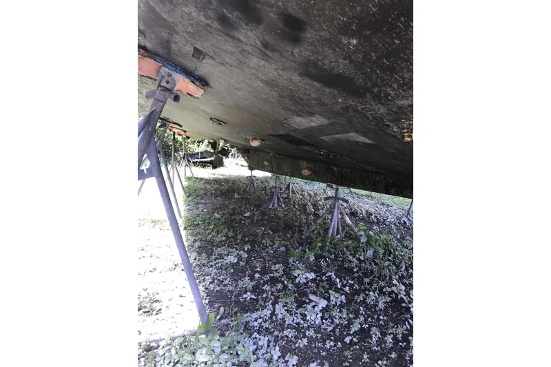 Slide: The Image of Underneath view of a 1999 Custom Sport Fishing boat on stands. - 4