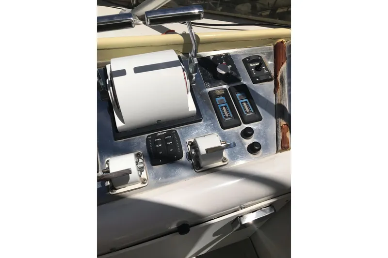 Slide: The Image of Control panel of a 1999 Custom Sport Fishing boat with various switches and levers. - 41