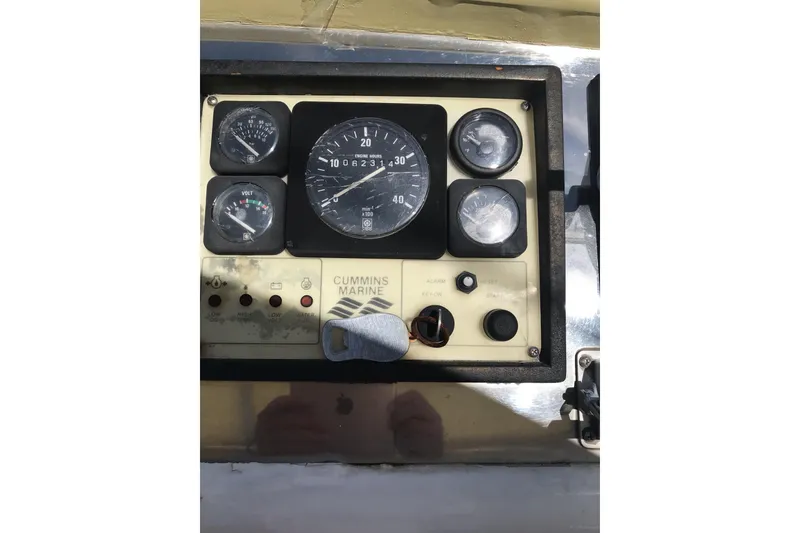 Slide: The Image of Instrument panel of a 1999 Custom Sport Fishing boat with Cummins Marine gauges. - 42