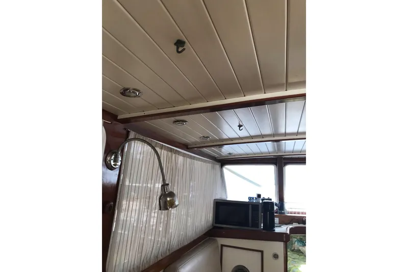 Slide: The Image of Interior of 1999 Custom Sport Fishing boat with wood paneling and modern amenities. - 50