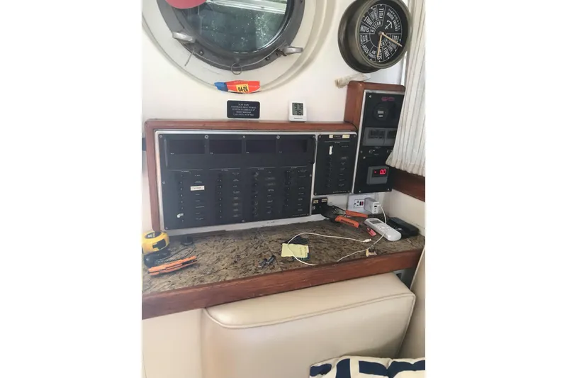 Slide: The Image of Control panel inside a 1999 Custom Sport Fishing boat, featuring various instruments and tools. - 52