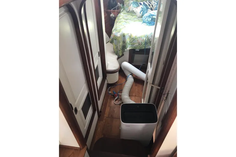 Slide: The Image of Interior of 1999 Custom Sport Fishing boat with air conditioning unit and cozy bed. - 53