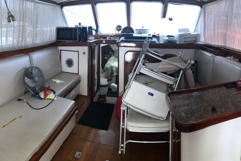 Slide: The Image of Interior of a 1999 custom sport fishing boat with seating and stacked chairs. - 55