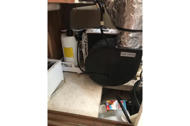 Slide: The Image of Engine compartment of a 1999 Custom Sport Fishing boat, showing mechanical components. - 56