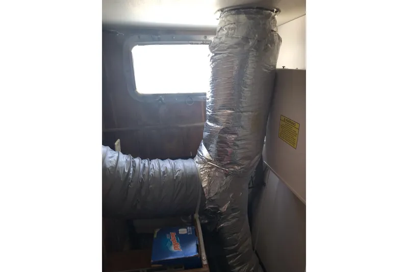 Slide: The Image of Interior of a 1999 Custom Sport Fishing boat with insulated ductwork and window. - 57