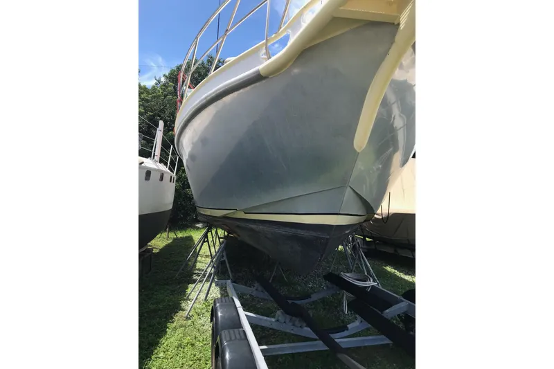 Slide: The Image of 1999 Custom Sport Fishing boat on trailer, viewed from below, outdoors. - 6