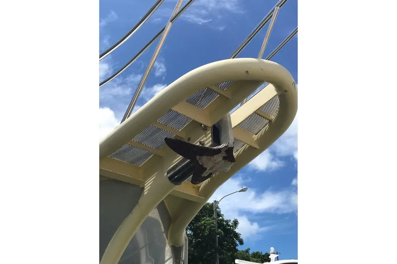 Slide: The Image of Custom 1999 Sport Fishing boat with a unique bow design against a clear blue sky. - 8