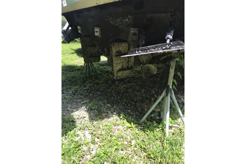 Slide: The Image of 1999 Custom Sport Fishing boat on stands, showing propeller and hull details. - 9