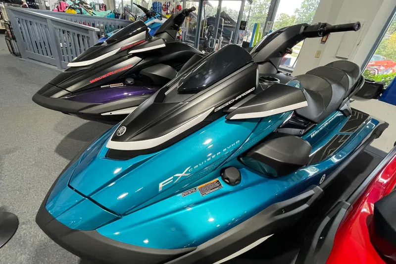 Slide: The Image of 2026 Yamaha WaveRunner FX Cruiser SVHO in showroom, sleek design, vibrant blue color. - 2