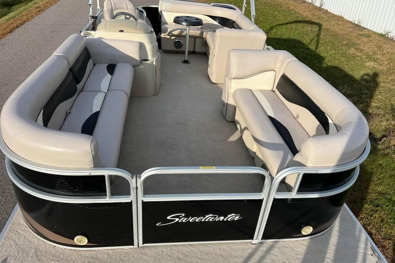 Slide: The Image of 2013 Godfrey Sweetwater 2286 pontoon boat with beige seating and black exterior. - 10