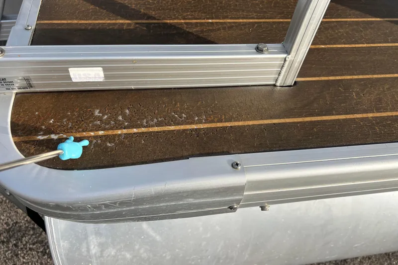 Slide: The Image of 2013 Godfrey Sweetwater 2286 boat deck with aluminum railing and wooden flooring. - 11