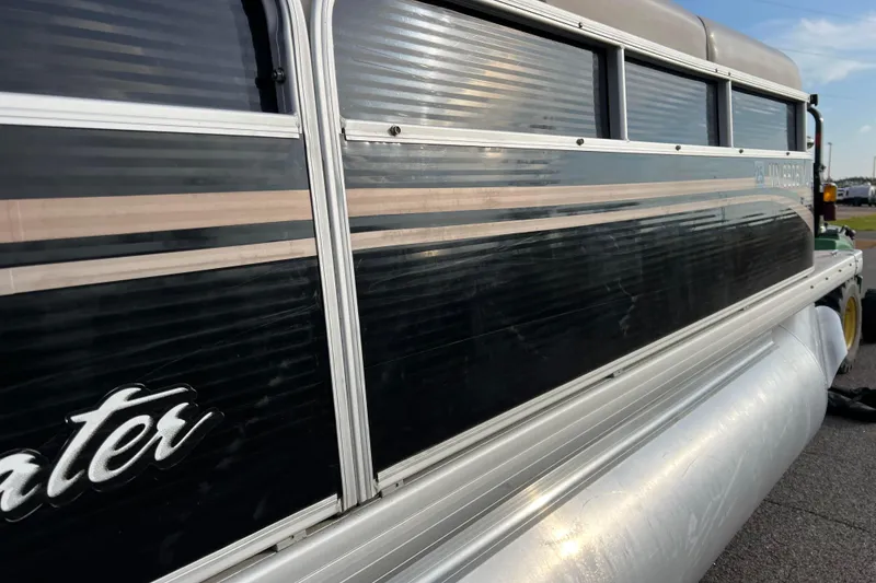 Slide: The Image of 2013 Godfrey Sweetwater 2286 pontoon boat side view with sleek design. - 12