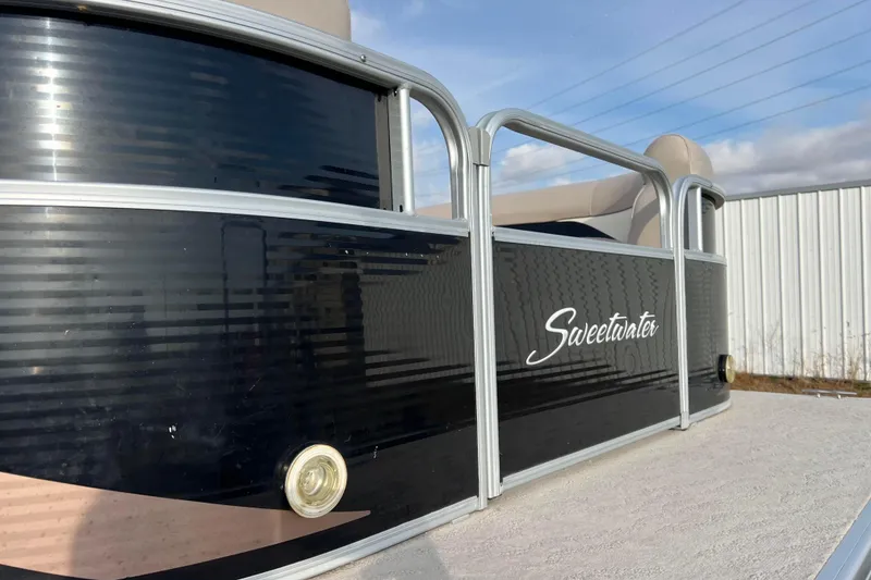 Slide: The Image of 2013 Godfrey Sweetwater 2286 pontoon boat with sleek black exterior and silver railing. - 16