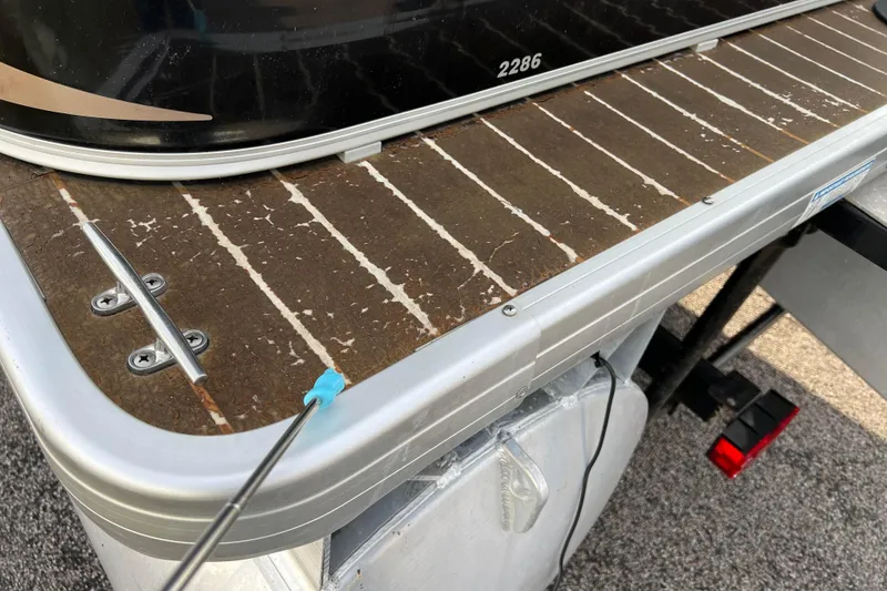 Slide: The Image of 2013 Godfrey Sweetwater 2286 boat deck with metal cleat and textured surface. - 23