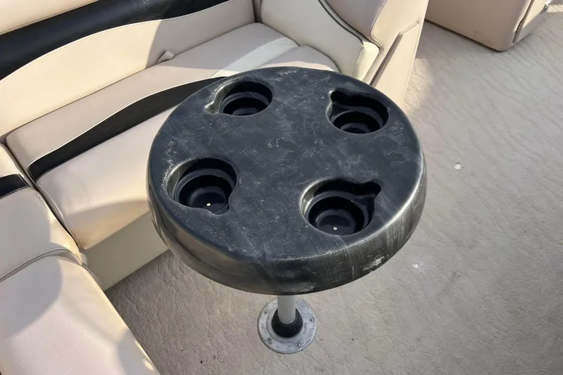 Slide: The Image of 2013 Godfrey Sweetwater 2286 boat interior with cup holder table and seating. - 27