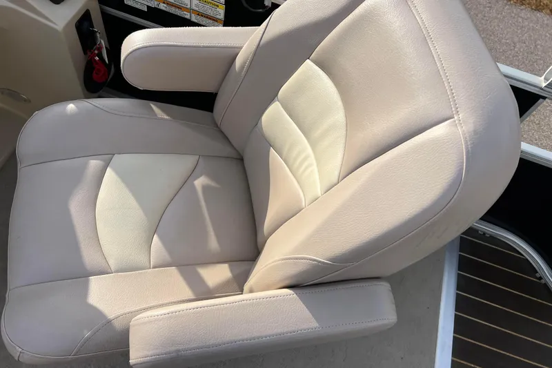 Slide: The Image of 2013 Godfrey Sweetwater 2286 boat seat, beige upholstery, armrests, and control panel. - 28