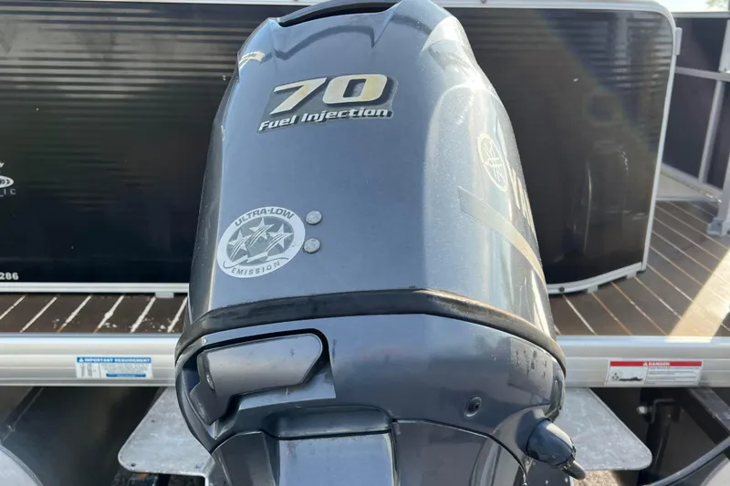 Slide: The Image of Outboard motor on 2013 Godfrey Sweetwater 2286 pontoon boat, featuring 70 HP fuel injection. - 3
