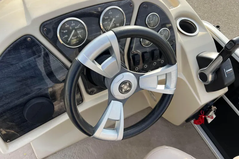 Slide: The Image of Steering console of 2013 Godfrey Sweetwater 2286 boat with gauges and controls. - 31