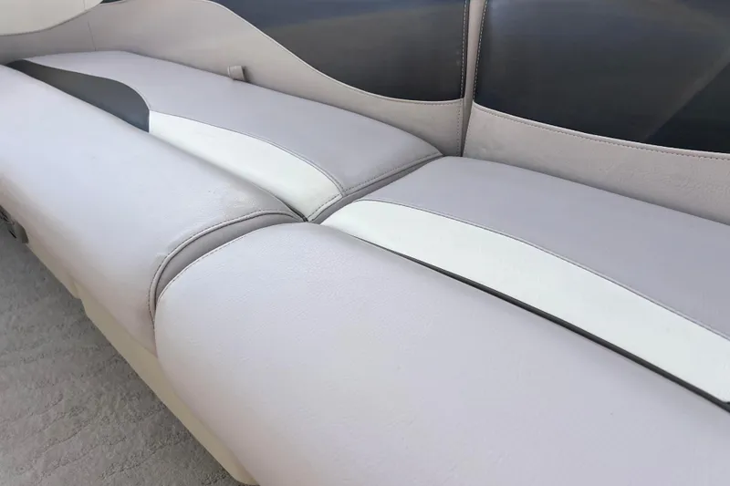 Slide: The Image of 2013 Godfrey Sweetwater 2286 boat interior seating, featuring light gray and white upholstery. - 35
