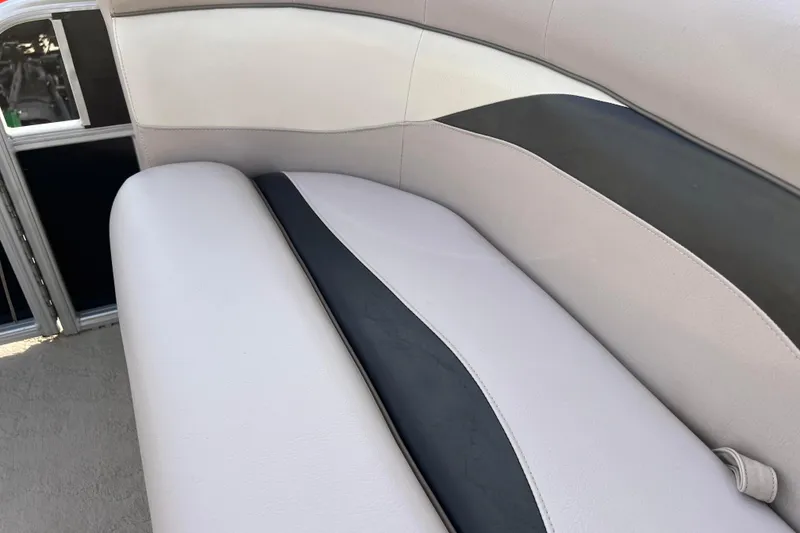 Slide: The Image of 2013 Godfrey Sweetwater 2286 boat interior with beige and black seating. - 37