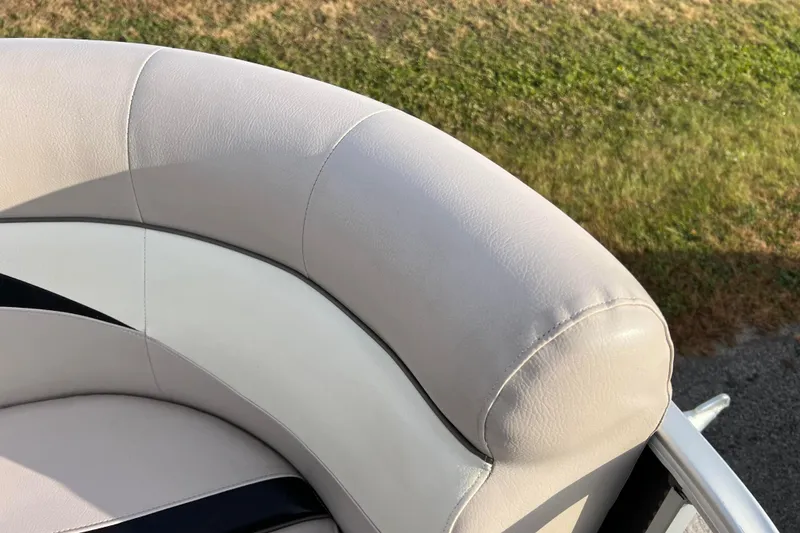 Slide: The Image of 2013 Godfrey Sweetwater 2286 boat seat with light gray upholstery, outdoor setting. - 40