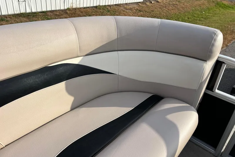 Slide: The Image of 2013 Godfrey Sweetwater 2286 boat seating with beige and black upholstery. - 41