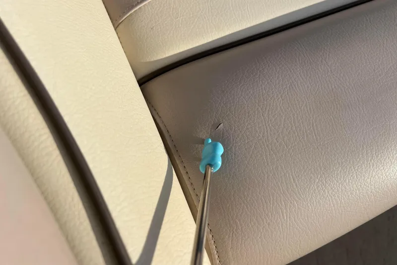 Slide: The Image of Close-up of a 2013 Godfrey Sweetwater 2286 seat with a small puncture. - 43