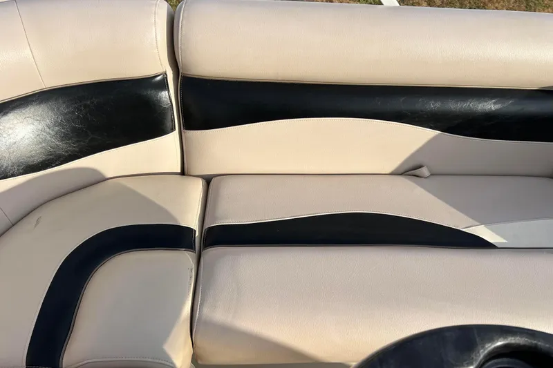 Slide: The Image of 2013 Godfrey Sweetwater 2286 boat seating with beige and black upholstery. - 46