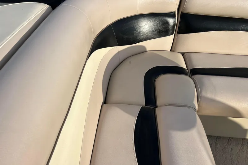Slide: The Image of Beige and black seating on 2013 Godfrey Sweetwater 2286 boat, showcasing luxury upholstery. - 47